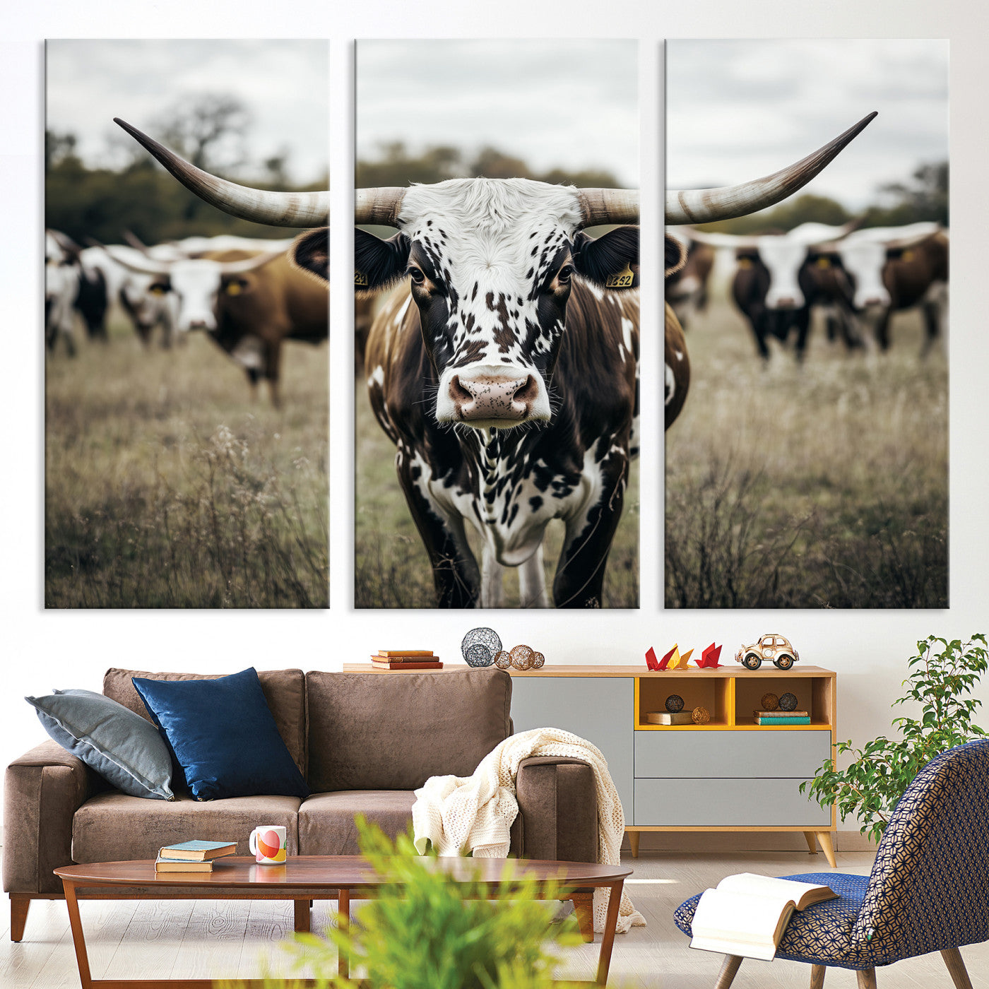 Canvas of a speckled Texas longhorn standing boldly in a field with a herd behind, perfect for rustic western or farmhouse wall decor.