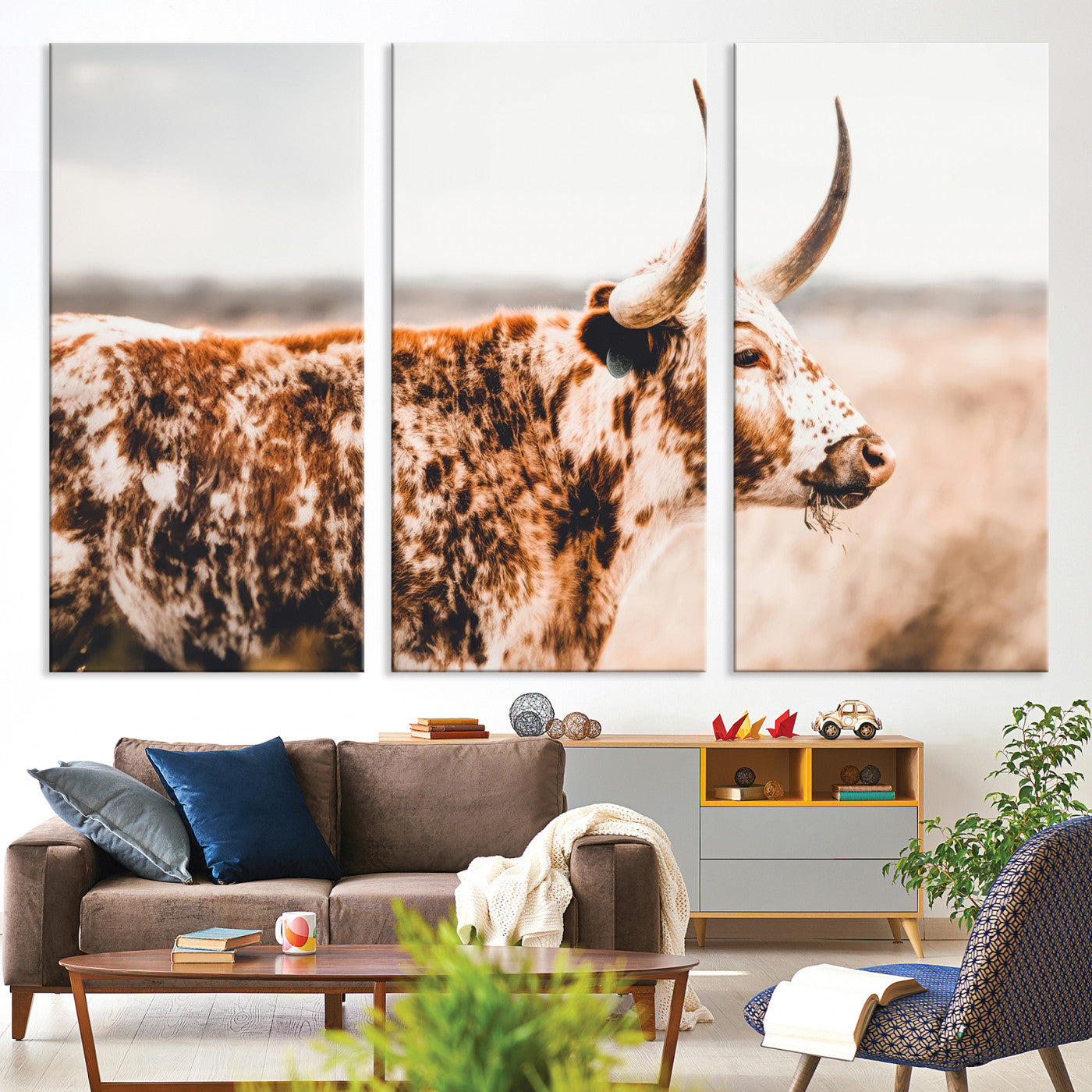 Speckled Texas longhorn with curved horns standing in a warm-toned prairie, perfect for rustic or country-style home decor.
