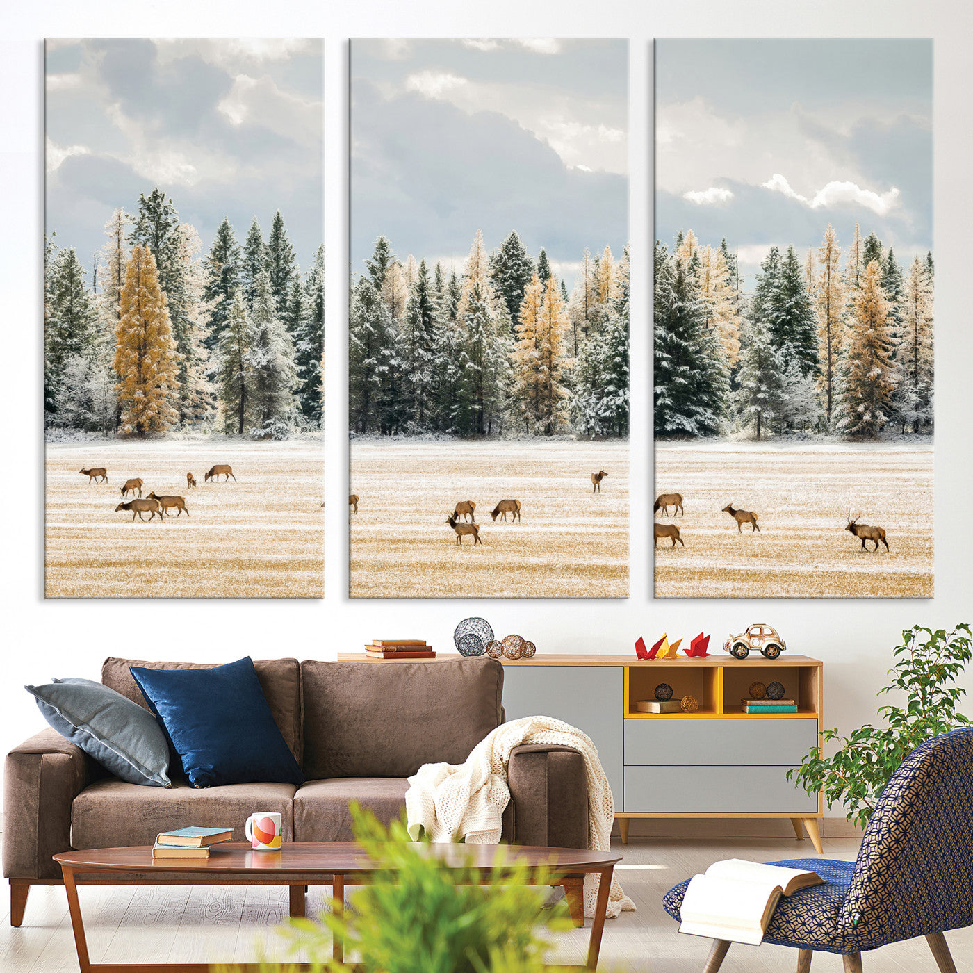 Elk herd in a snowy field with golden pine trees and frosted evergreens, ideal for neutral rustic or cabin-style home decor.