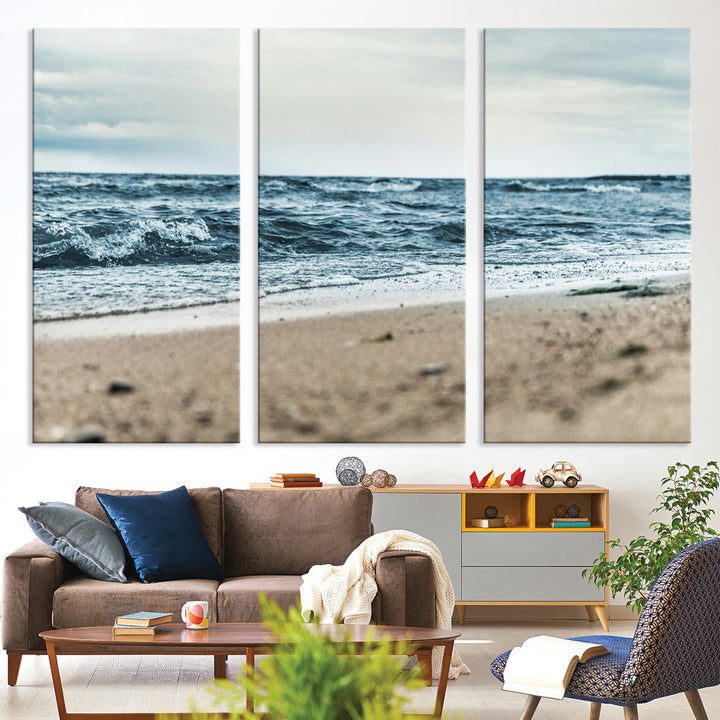 A moody ocean scene with gentle waves washing onto a sandy beach under a cloudy sky, creating a peaceful and coastal atmosphere.