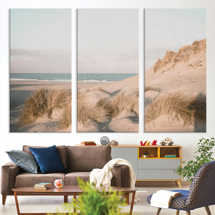 Soft pastel-toned beach scene with sand dunes, windswept grasses, and a calm ocean horizon, creating a serene coastal atmosphere.