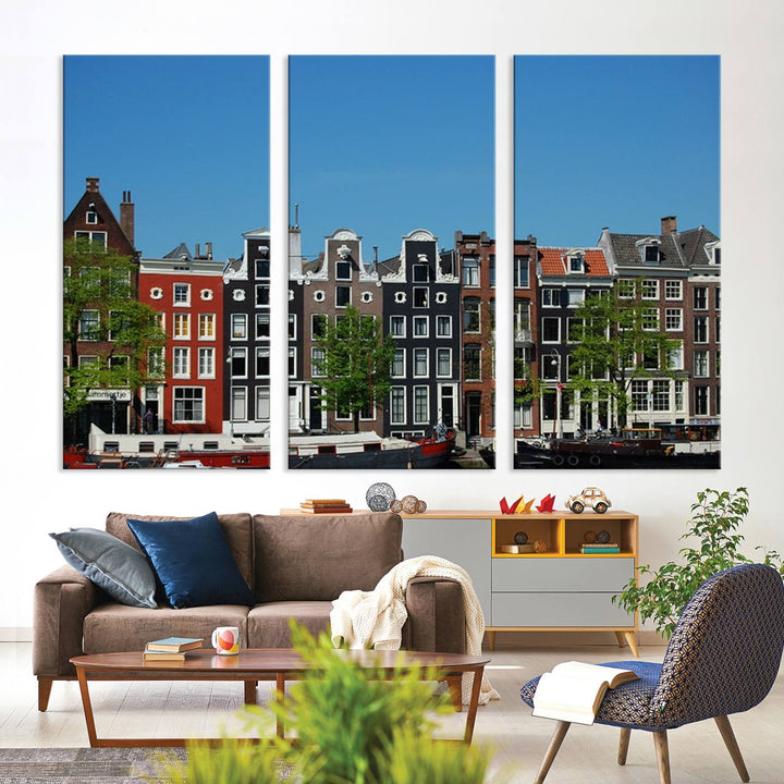 The Amsterdam City Wall Art Canvas Print showcases colorful traditional canal houses and boats set against a clear blue sky.