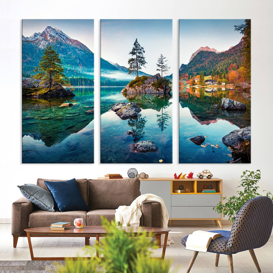 The 3-panel wall art showcases a serene mountain lake with rocky islands and trees, creating an ideal focal point for dining rooms or offices.