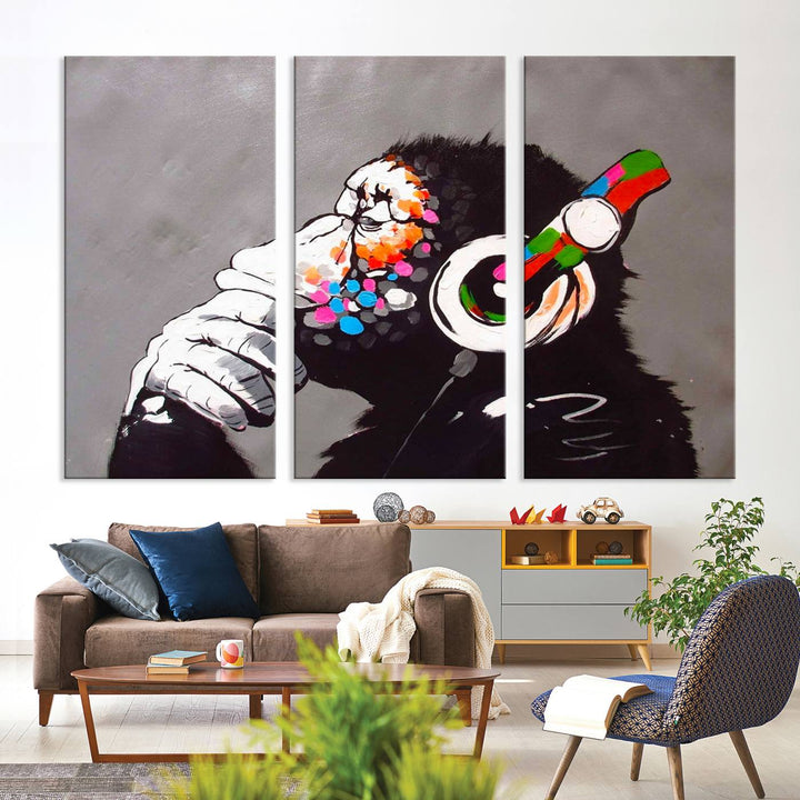 A vibrant triptych, the "DJ Monkey Listening to Music" wall art print, features a Banksy-inspired large canvas adorned with colorful modern pop art. This striking piece elegantly enhances the room with its dynamic and lively depiction.