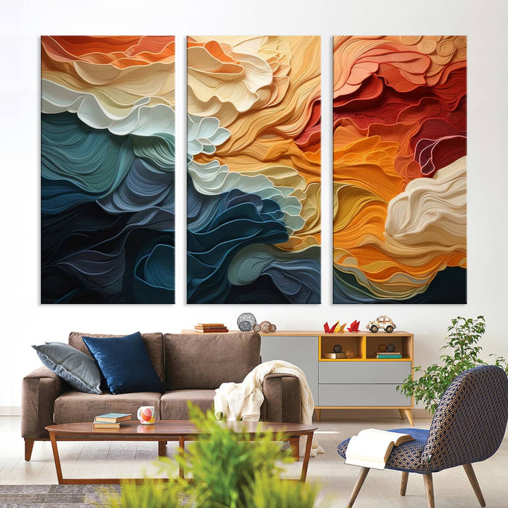 A Blue Orange Abstract Wave Wall Art Canvas Print adorns the wall. This colorful masterpiece is professionally hand-assembled to enhance any space.