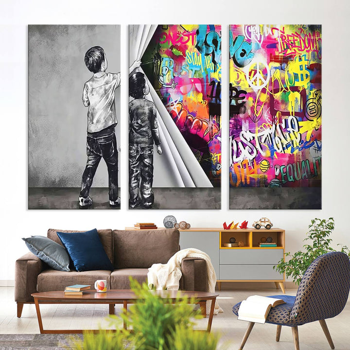 The Banksy Print - Street Art Canvas features a vibrant and bold image of two children lifting a curtain to reveal colorful graffiti. It's ready to hang, adding an urban modern decor vibe.