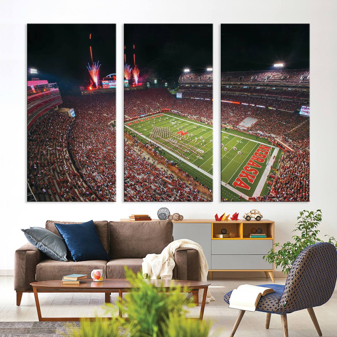 The University of Nebraska Cornhuskers Football Team Print, featuring Lincoln Memorial Stadium in a vibrant triptych canvas with fireworks above and a gallery-quality finish, is elegantly displayed.