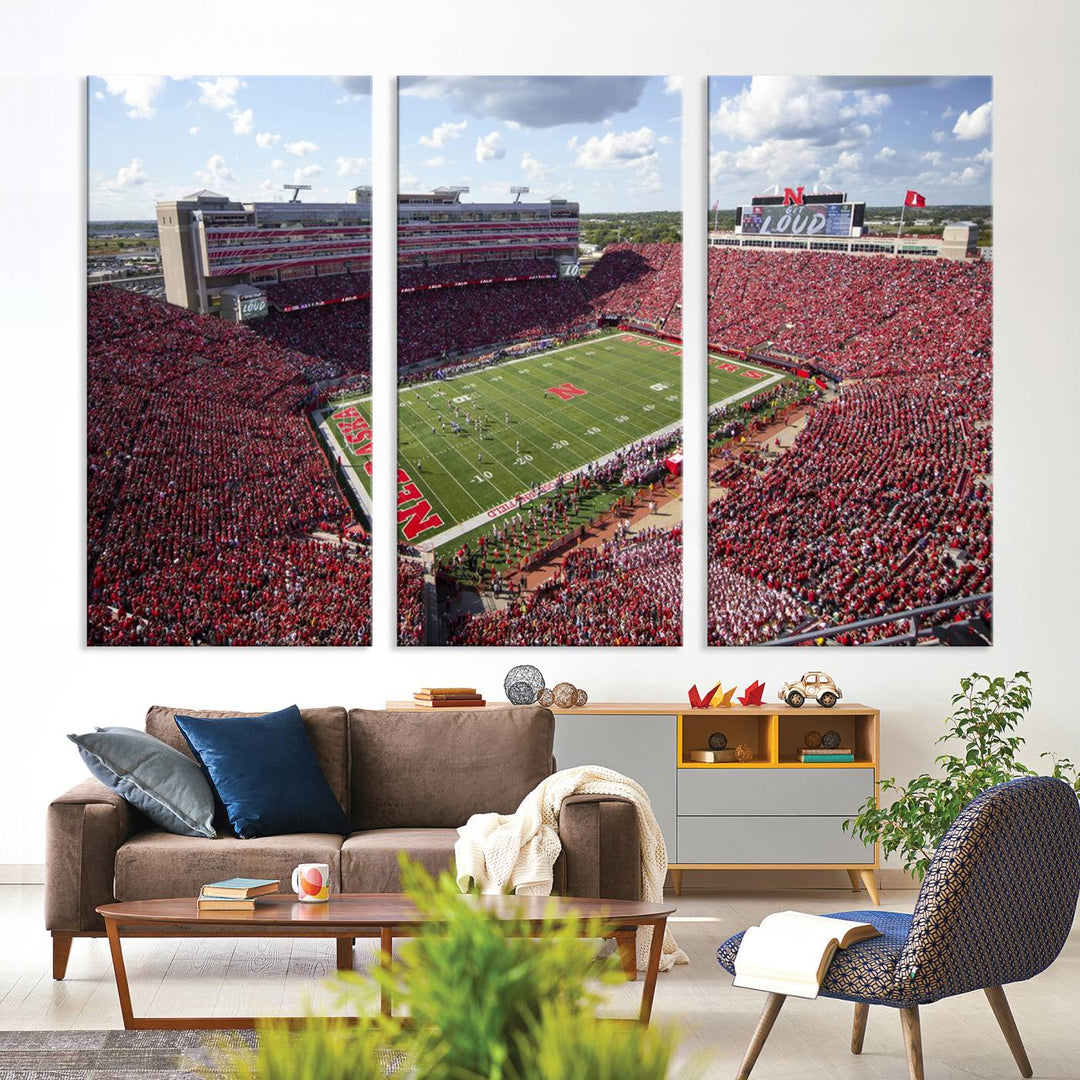 The University of Nebraska Cornhuskers Football Team Print showcases a vibrant triptych of Lincoln Memorial Stadium, depicting a packed football stadium filled with energetic fans. This handmade art piece is crafted in the USA and printed on premium canvas for a gallery-quality finish.