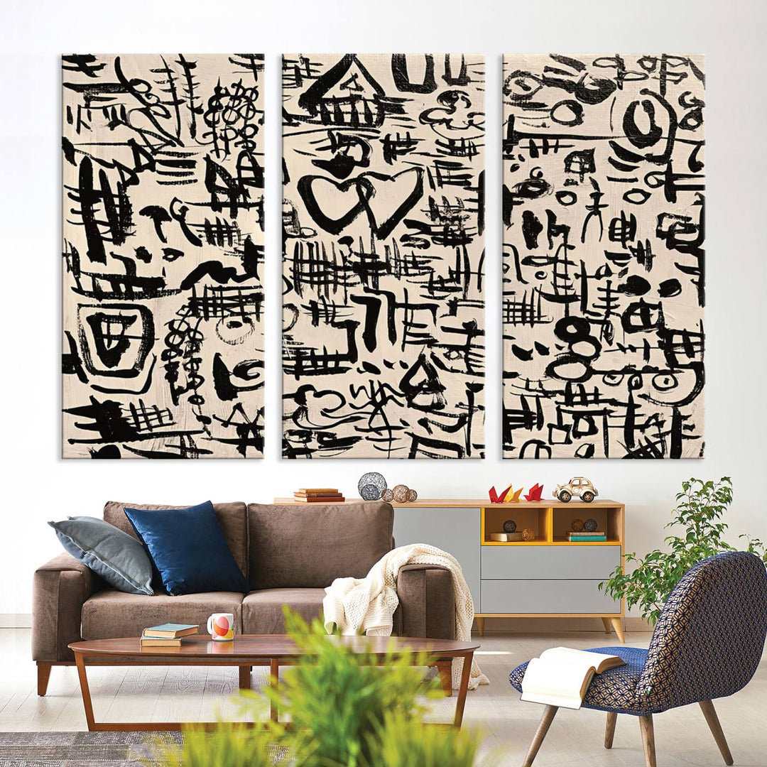 The Abstract Love and Chaos canvas is a museum-quality print featuring black symbols on a beige background, adorned with a heart and scribble design. It is framed to enhance its artistic appeal.