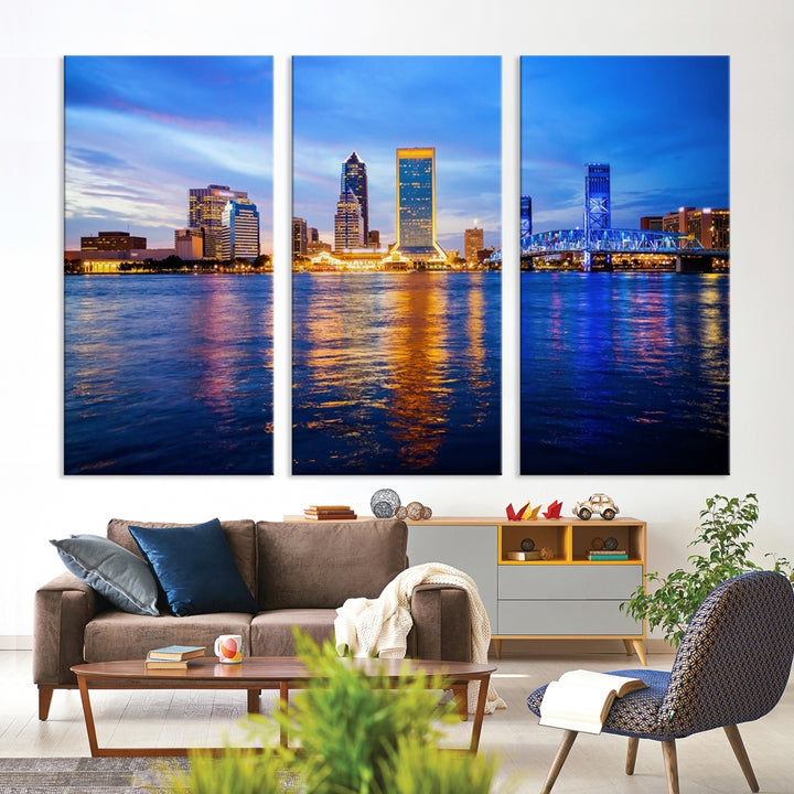 A cozy living room features the Jacksonville Wall Art Canvas Print, a large triptych crafted on museum-quality canvas that beautifully depicts the Jacksonville city skyline at sunset.