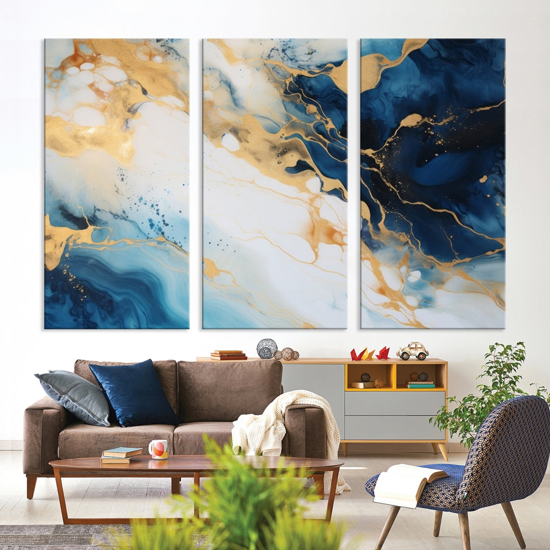 A modern living room featuring museum-quality Blue Gold Abstract Wall Art Print Contemporary art in a triptych arrangement.