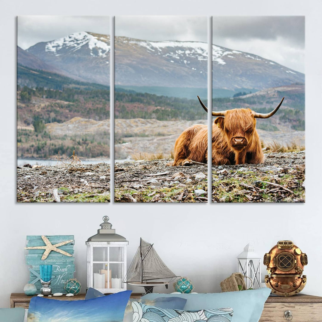 Highland Cow Horn Farm Wall Art Canvas Print is displayed against a wooden wall featuring a mountainous backdrop.