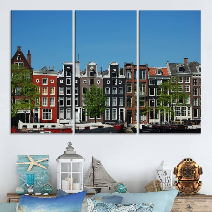 The Amsterdam City Wall Art Canvas Print showcases colorful traditional canal houses and boats set against a clear blue sky.