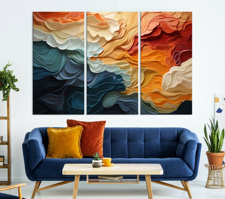 A Blue Orange Abstract Wave Wall Art Canvas Print adorns the wall. This colorful masterpiece is professionally hand-assembled to enhance any space.