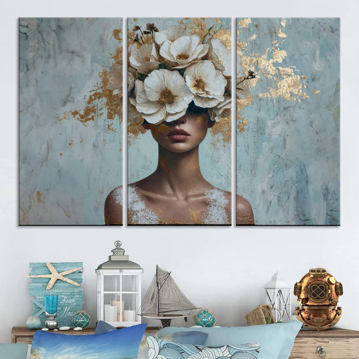 The Golden Petal Silhouette Woman Wall Art Canvas Print, a large 3-panel canvas with a textured gold floral design, serves as a luxurious centerpiece in modern glam settings. The artwork depicts a woman with flowers over her eyes against a textured background and hangs elegantly.