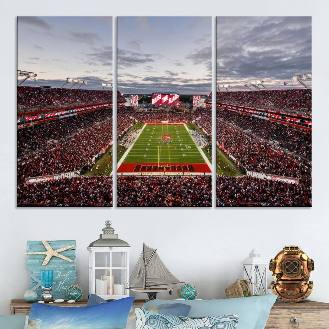 The wall art captures a stunning scene of Raymond James Stadium bathed in the warm hues of sunset. The sky, filled with clouds, provides a dramatic contrast to the vibrant lighting on the field, encapsulating the dynamic energy of a football game.