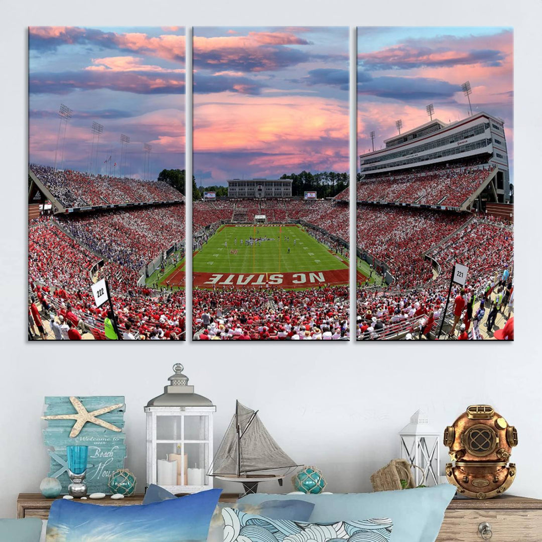 The wall art captures an NC State Wolfpack game under a vibrant sunset on triple canvas.