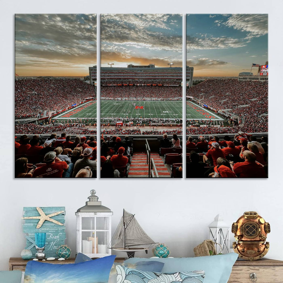 The living room features a stunning triptych of Lincoln Memorial Stadium wall art canvas print, celebrating the University of Nebraska Cornhuskers football team. This piece serves as captivating wall art, showcasing a gallery-quality finish.