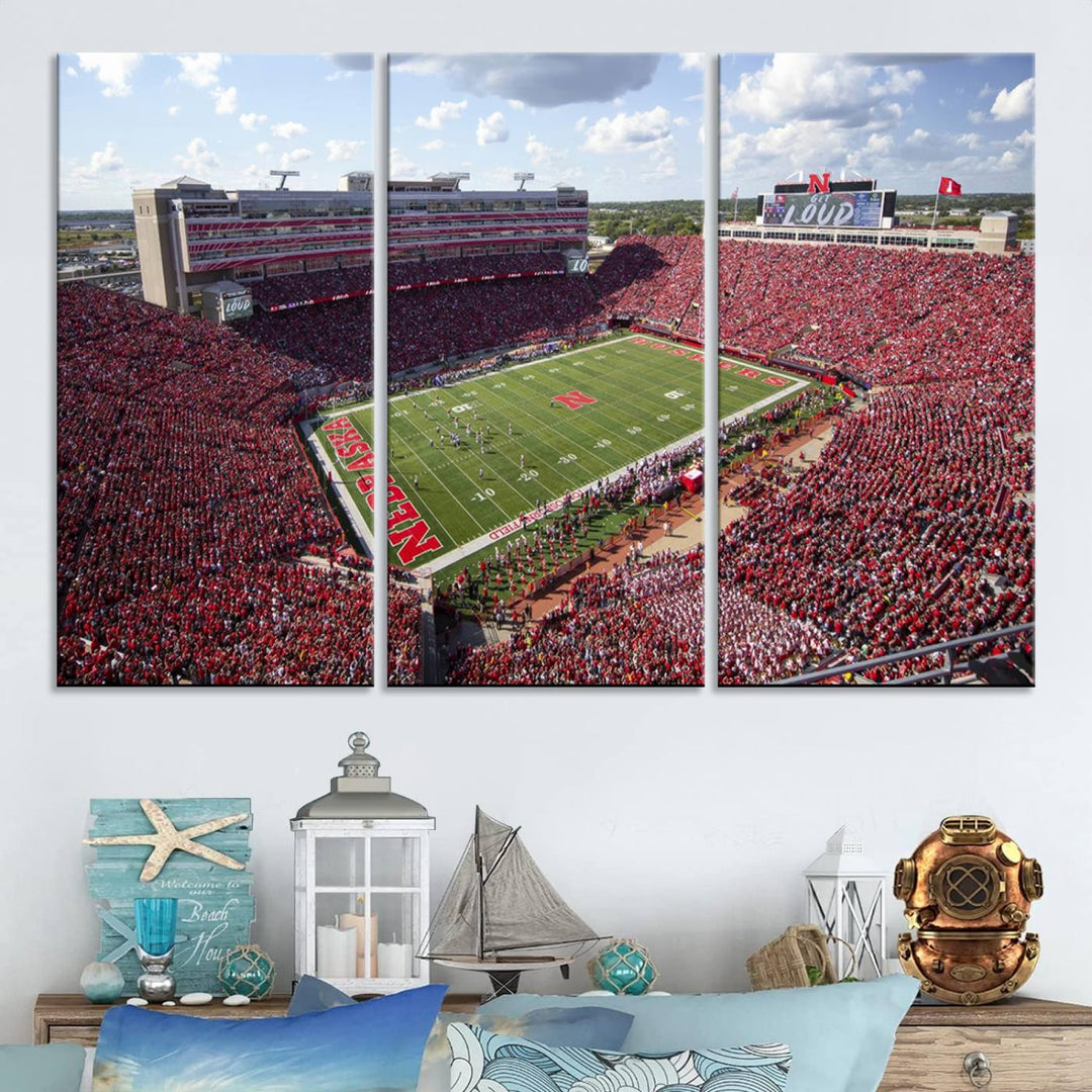 The University of Nebraska Cornhuskers Football Team Print showcases a vibrant triptych of Lincoln Memorial Stadium, depicting a packed football stadium filled with energetic fans. This handmade art piece is crafted in the USA and printed on premium canvas for a gallery-quality finish.