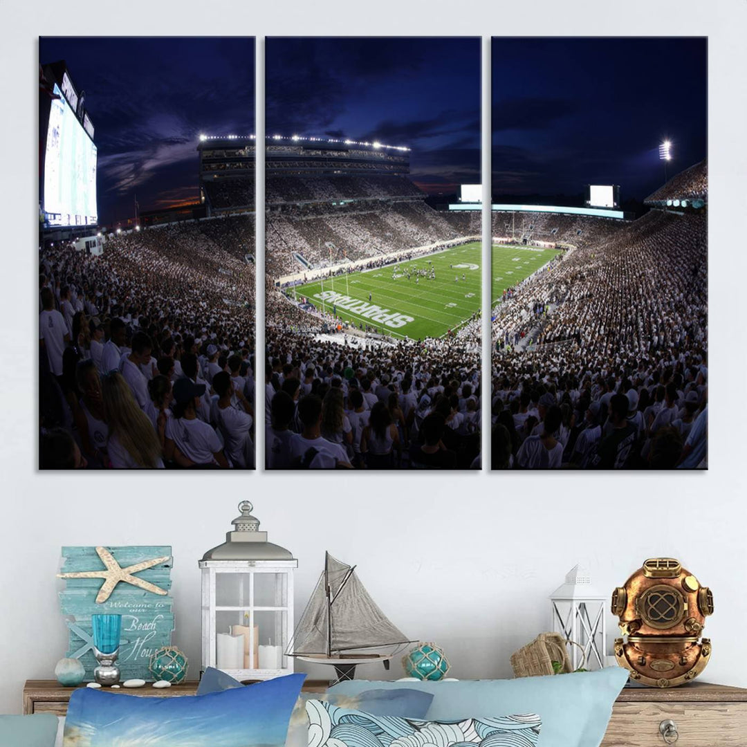 A packed football stadium at night, with bright lights and fans in white, depicted in a Michigan State Spartans Stadium wall art.