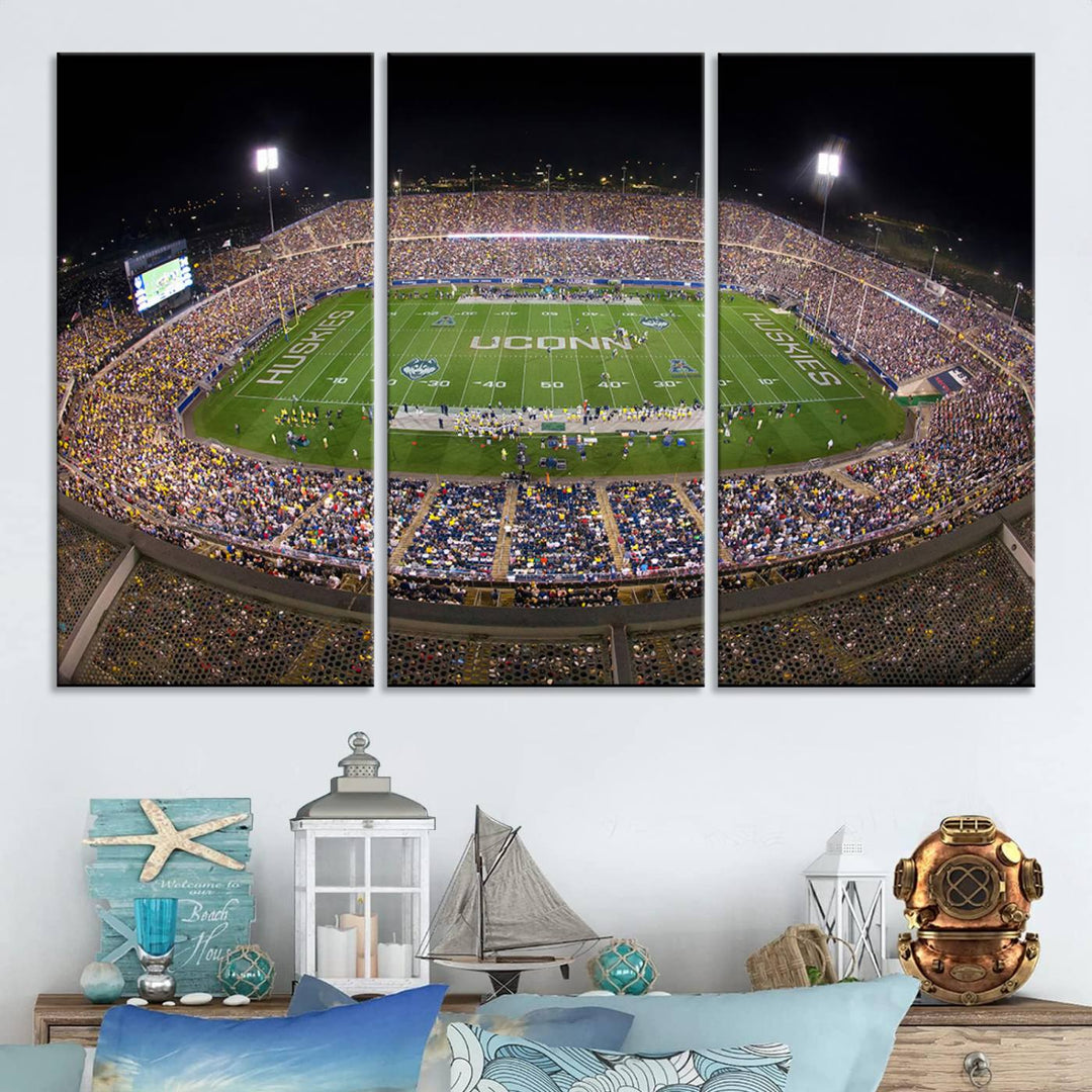 A large football stadium at night, featuring the UCONN Huskies, is depicted on the East Hartford Pratt & Whitney Stadium Wall Art Canvas Print.