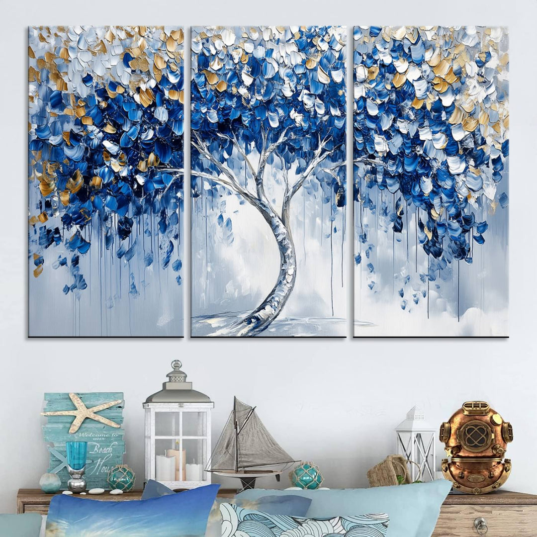 The Blue and Gold Abstract Tree Wall Art showcases a swirl trunk and features blue, silver, and gold leaves on a framed canvas print.