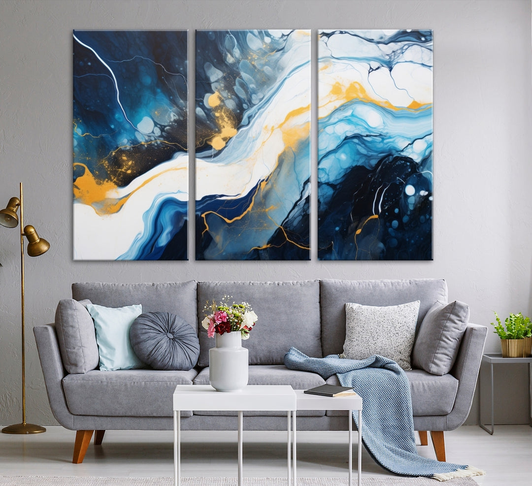 The Navy Blue Abstract Wall Art Canvas Print, displaying an exquisite array of blue, white, and gold swirls, is crafted on museum-quality canvas and enhances the space with its sophisticated elegance.