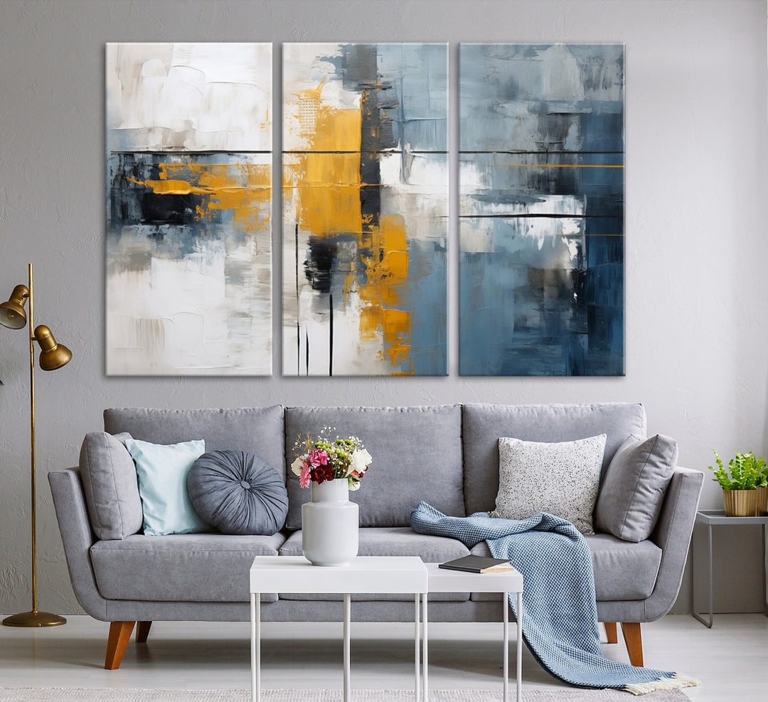 The Orange Abstract Wall Art Print features a series of white, blue, black, and yellow blocks arranged in a triptych format on museum-quality canvases. Proudly made in the USA and offered with free shipping.