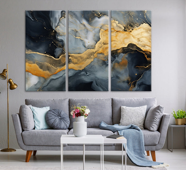 The living room features the Golden Gray Abstract Wall Art Print Contemporary Art Canvas Design, a triptych showcasing gold, black, and gray swirls. Crafted on museum-quality canvas and ready to hang, this piece is designed for elegance and durability.