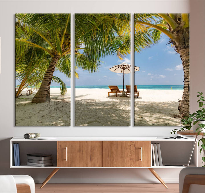 The canvas art print titled Lounge Chairs Palm Trees on Tropical Beach offers free shipping.