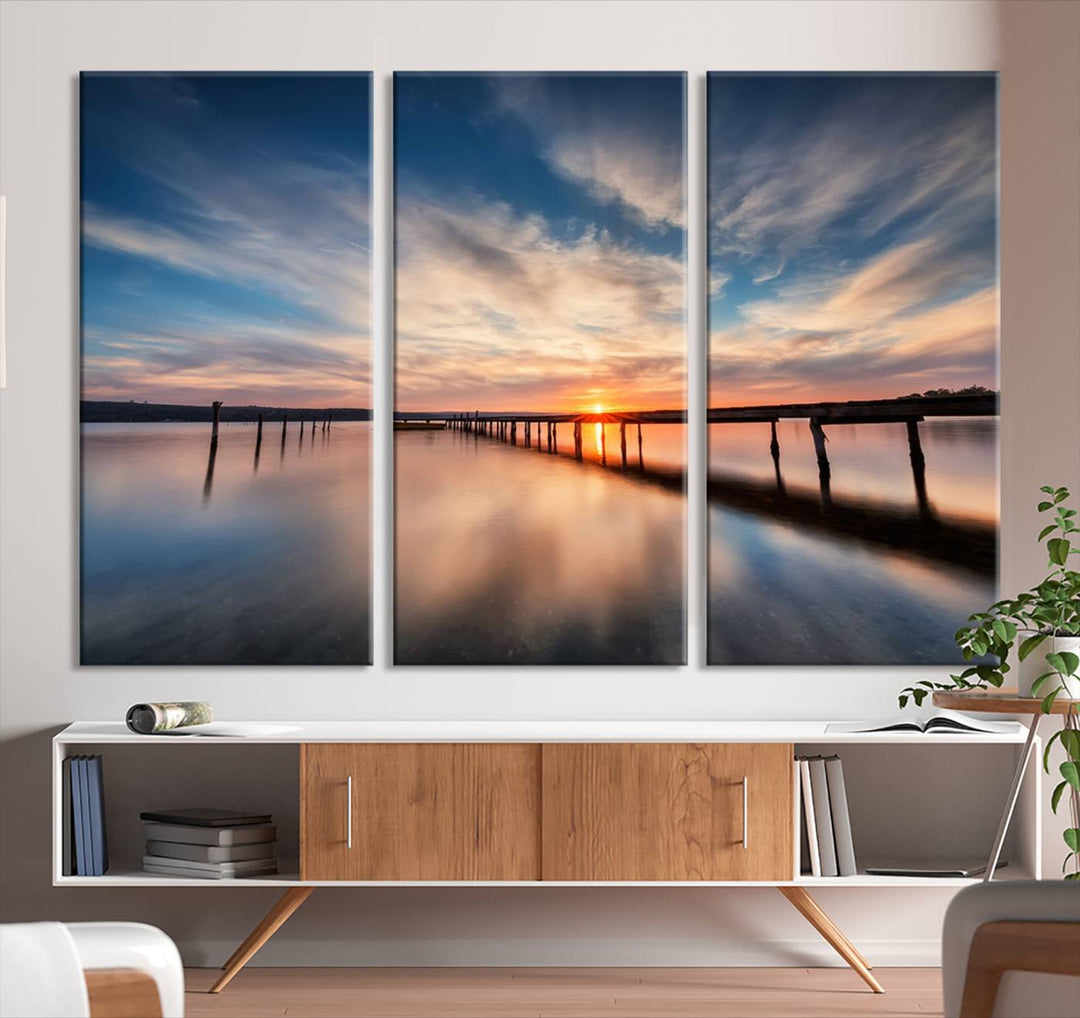 The Sunset Pier Canvas features a serene coastal landscape with vibrant hues under cloudy skies, ideal for modern decor.