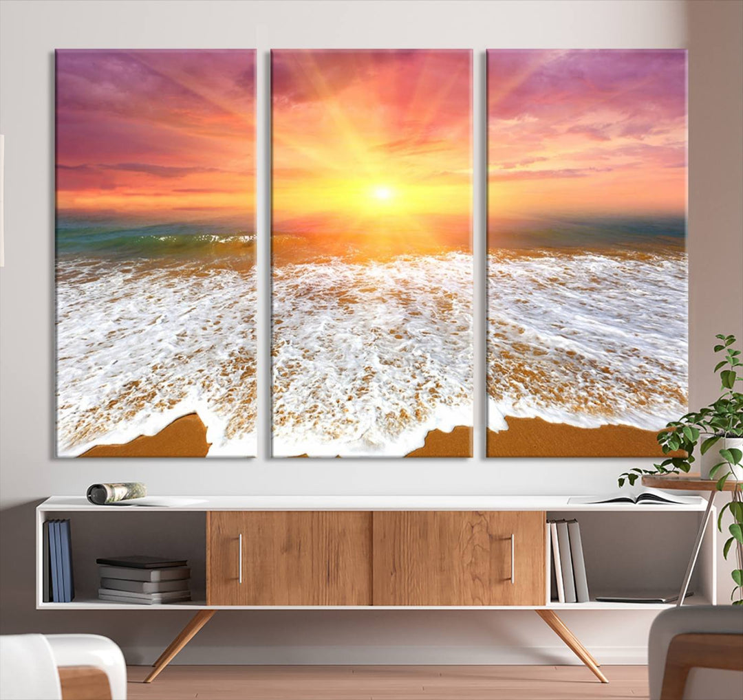 Golden Beach Sunrise 3-panel canvas art of ocean waves, hung on a wooden wall.