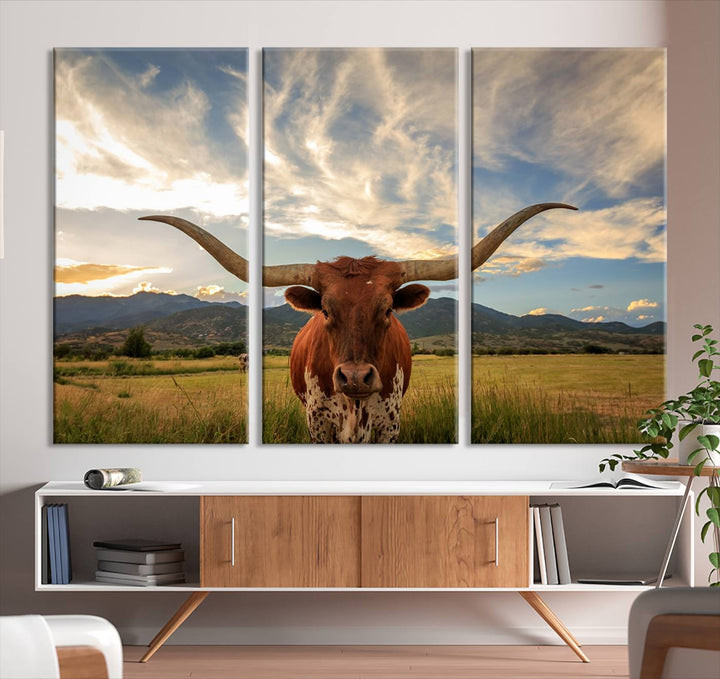 The Texas Longhorn Canvas Wall Art showcases a majestic longhorn steer in a field encircled by mountains under a cloudy sky. Ideal for enthusiasts of rustic western decor, this piece beautifully captures the essence of majestic triptych animal print.