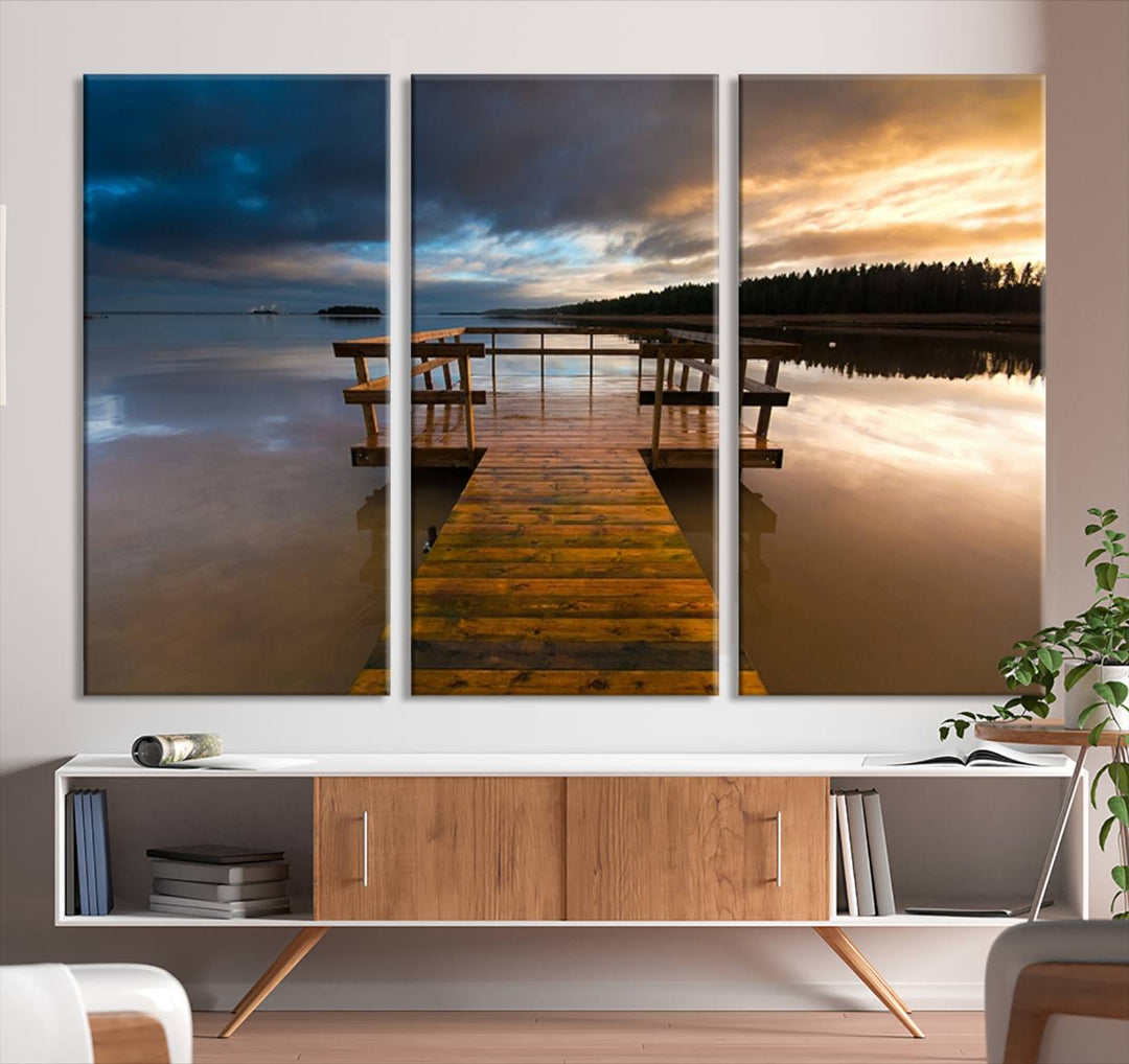 The "Serene Lake Pier at Sunset" landscape canvas print, crafted as ready-to-hang and framed wall art, enriches the contemporary setting by capturing the tranquility of a lakeside pier at sunset.