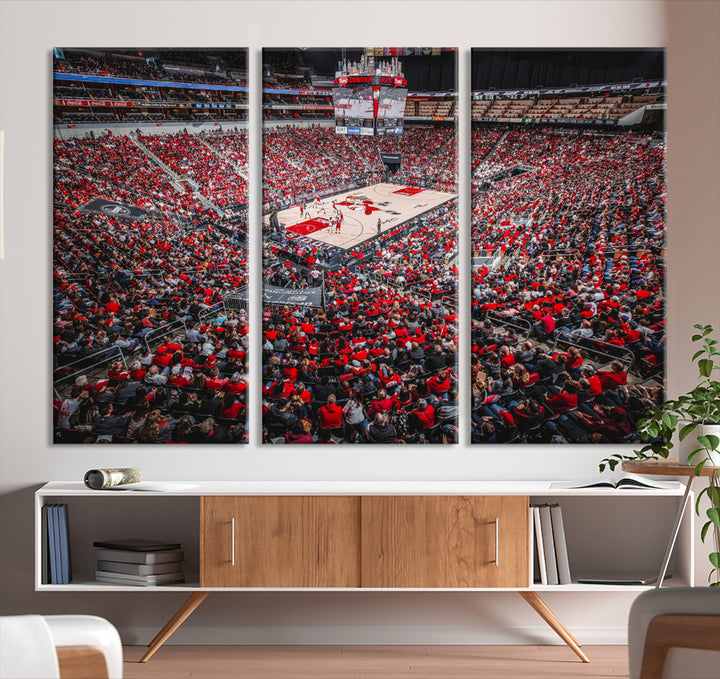 A painting of Louisville Cardinals fans in red at the KFC Yum Center Arena.