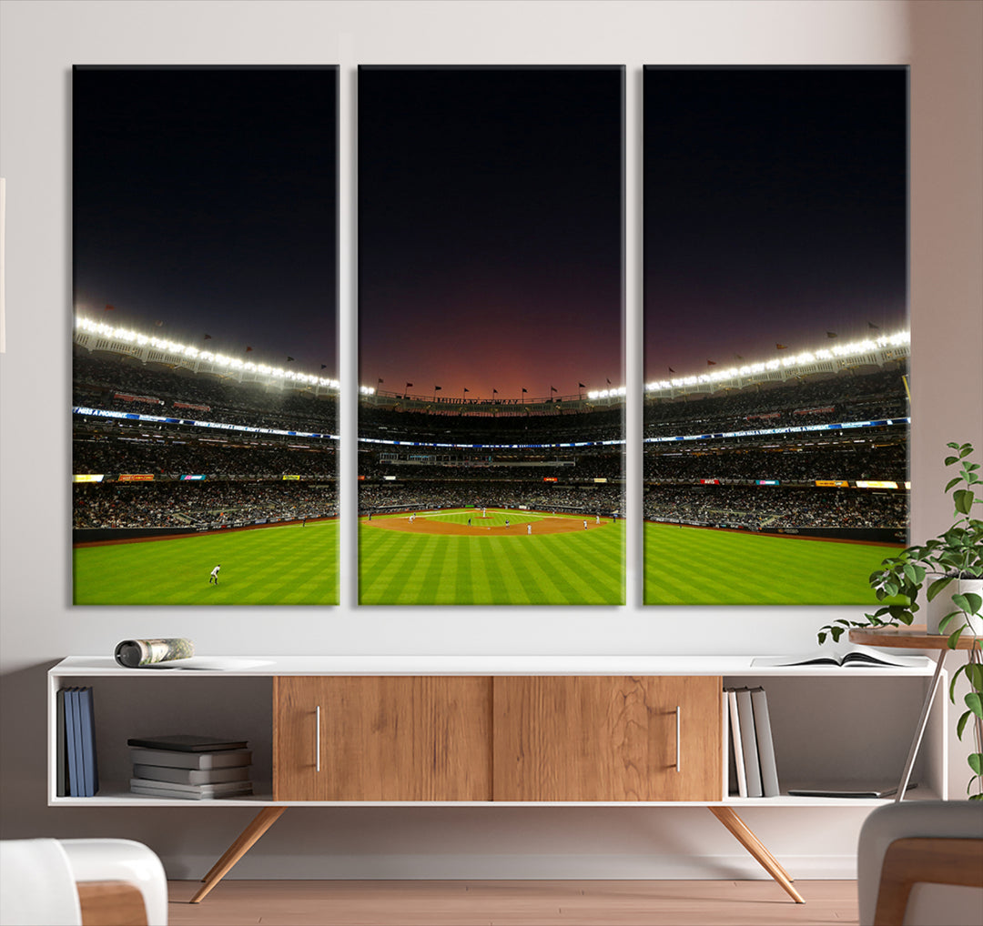 A night game at Yankee Stadium depicted on canvas beneath a sunset sky.