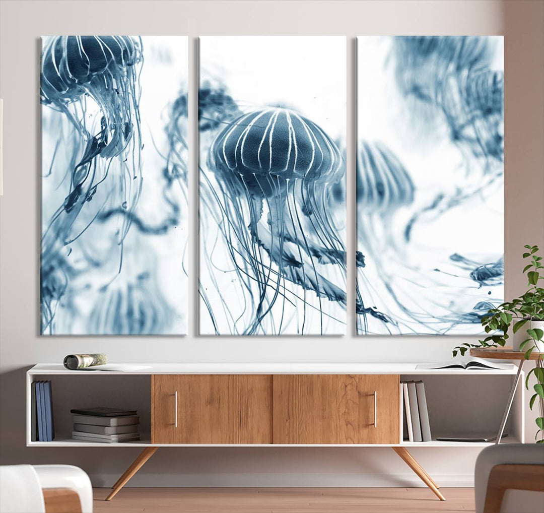 The "Abstract Jellyfish Wall Art Canvas Print" in high resolution is beautifully displayed as a triptych on a dark wall. Experience museum-quality canvas and enjoy free shipping with this stunning piece.