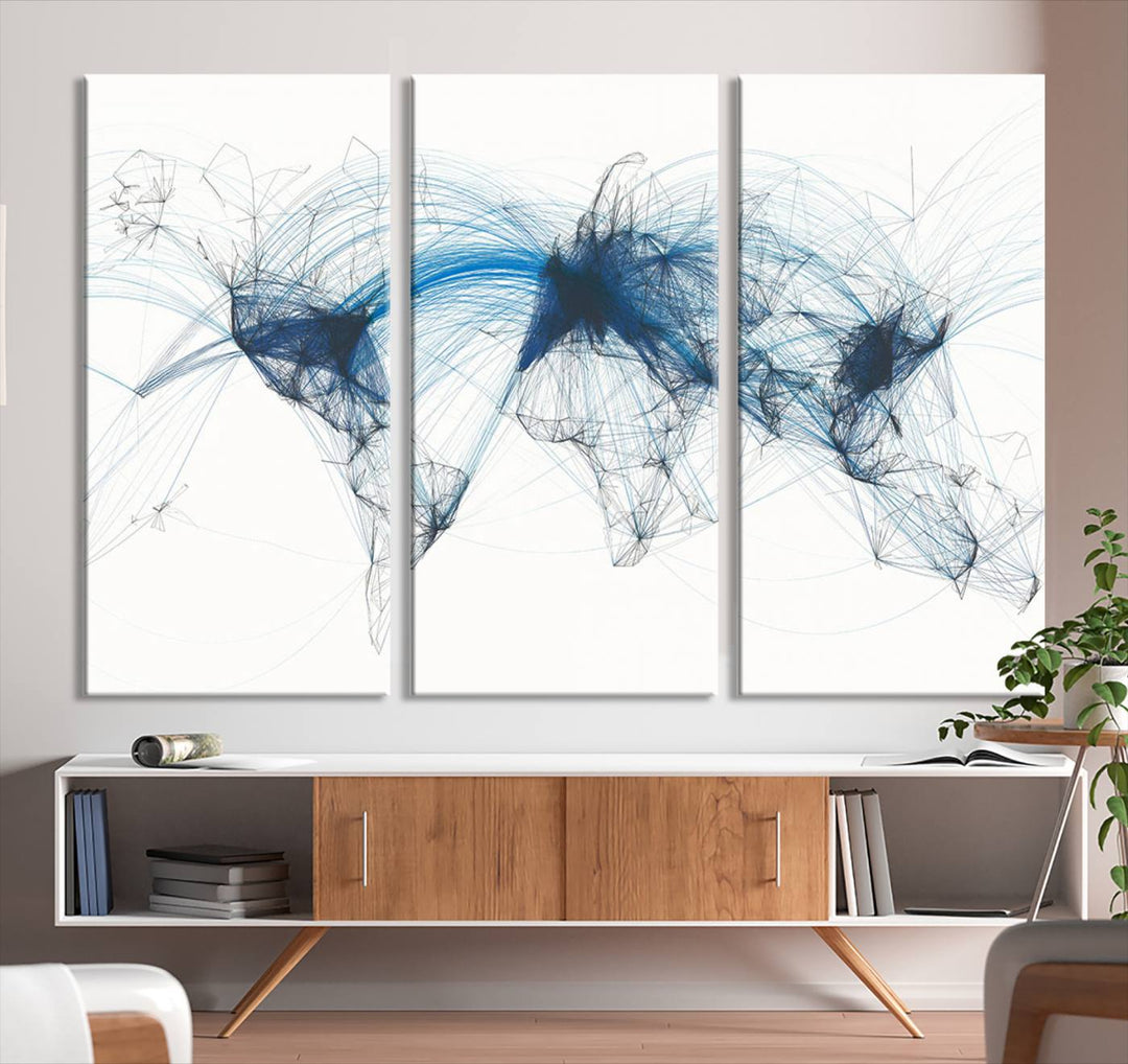 The Aviation Flight Map Wall Art is a set of three abstract panels featuring a world map with blue lines, resembling a flight map. Ideal for aviation enthusiasts, this ready-to-hang framed air traffic art print enhances the appeal of modern decor.