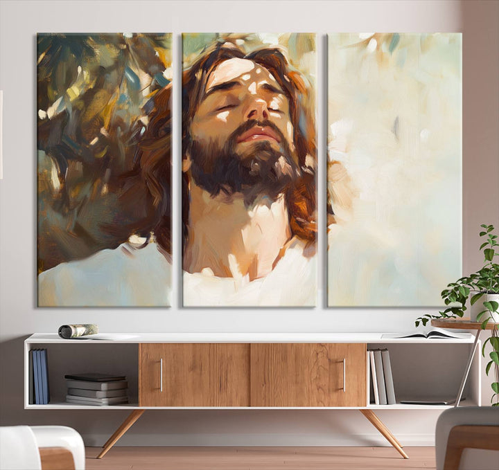 The Jesus Portrait Wall Art Canvas Print features a depiction of Jesus Christ with closed eyes, basking in sunlight. His expression exudes a peaceful, spiritual atmosphere against a blurred background.