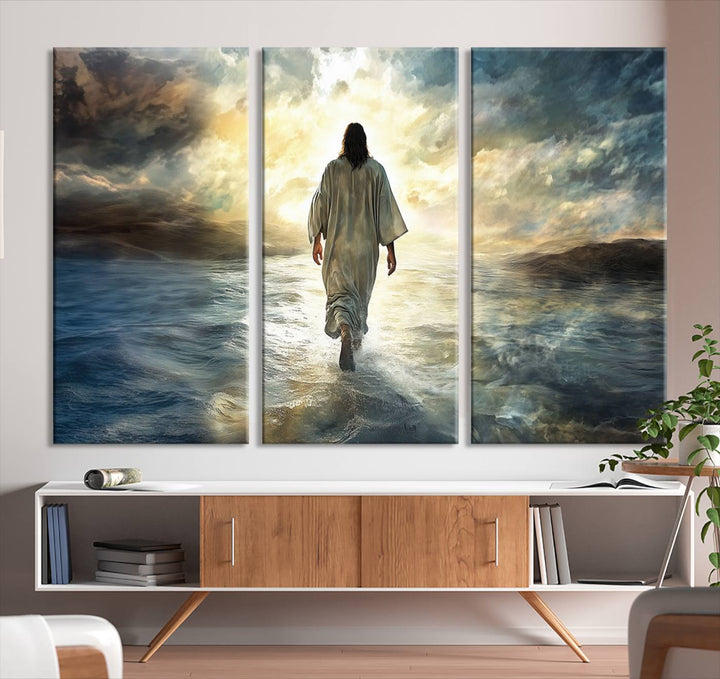 The Jesus Walking on Water Wall Art, a captivating triptych canvas print, showcases a person walking on water beneath dramatic clouds. This ready-to-hang piece seamlessly combines faith and style for your Christian home decor.