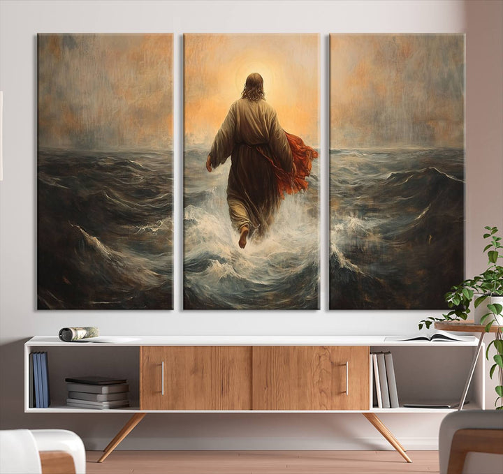 A modern living room is adorned with a triptych titled "Jesus Walking on Water, Christian Wall Art, Jesus Christ Walking on Oil Painting Style Print." The artwork, presented on museum-quality canvas, showcases vibrant colors and exquisite detail.