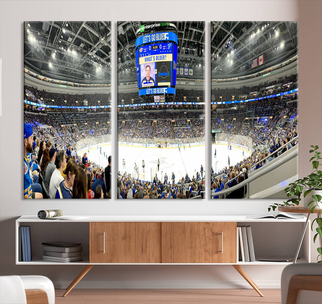 Wall art prints depicting the bustling scenes of the St. Louis Blues being cheered on by a full house at the Enterprise Center, beneath a large scoreboard.