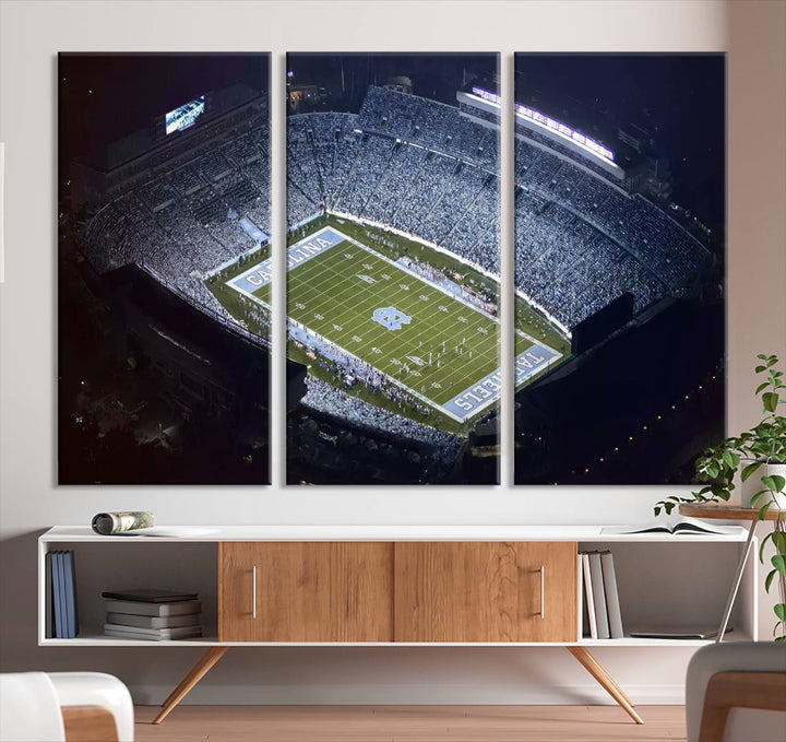 A University of North Carolina Tar Heels Football Team Print, showcasing Chapel Hill's Kenan Memorial Stadium, hangs in a modern dining room, adding a gallery-quality finish that enhances the entire space.