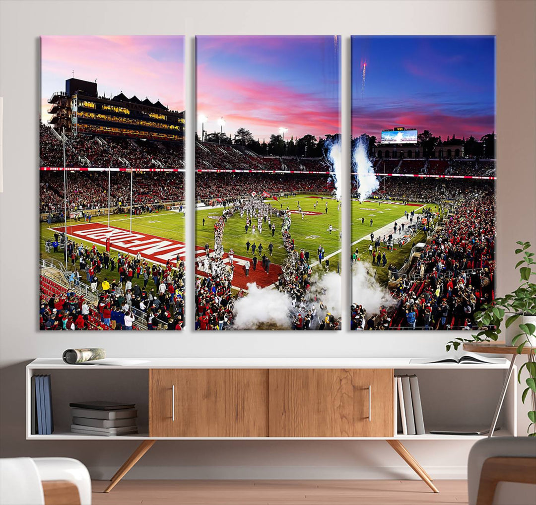 The wall art features a canvas print of the Stanford Cardinal football team, capturing players, fireworks, and smoke against the backdrop of a sunset at Stanford Stadium.