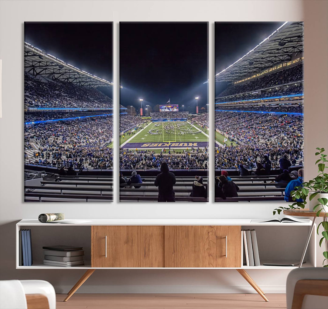 A canvas print titled The University of Washington Huskies Football depicts a packed Husky Stadium at night, as seen from the stands.