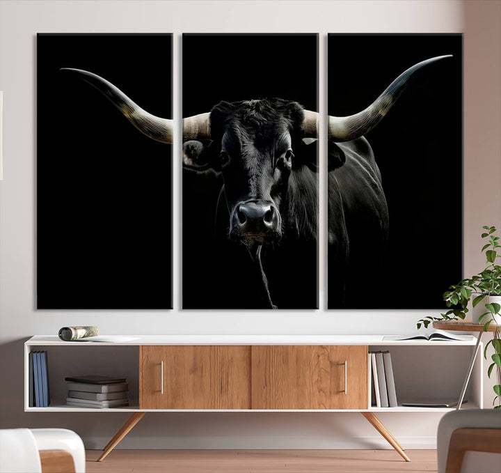 The Texas Black Longhorn Bull Canvas Print, featuring large curved horns set against a dark background, is ideal for Western decor.