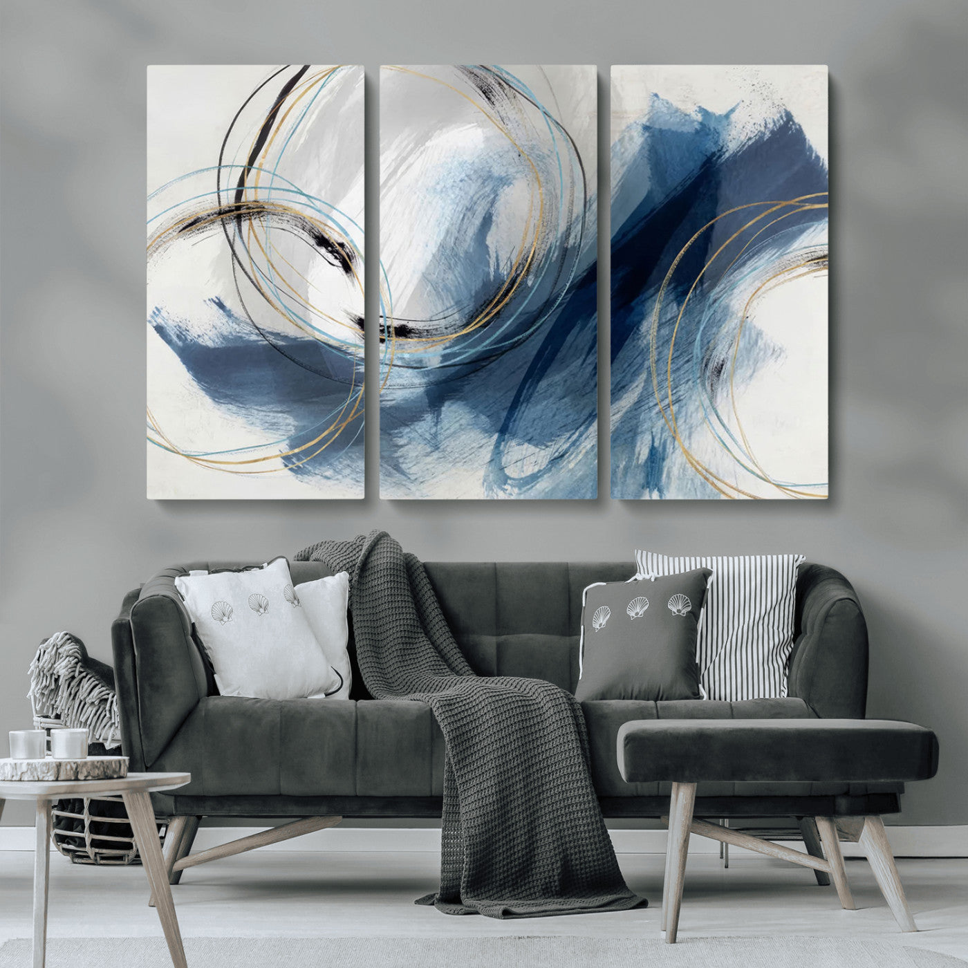 Abstract wall art featuring dynamic brush strokes in shades of blue and gray, overlaid with delicate circular line patterns in gold, black, and light blue on a white background.
