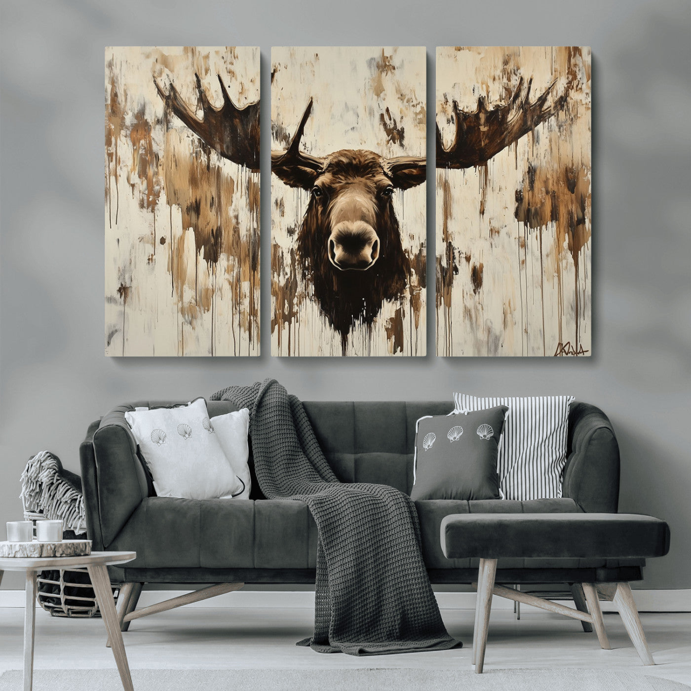 Expressive painting of a moose head with wide antlers in dark brown and beige tones, featuring paint drips and splatters on a light textured background, creating a striking rustic wall art canvas.