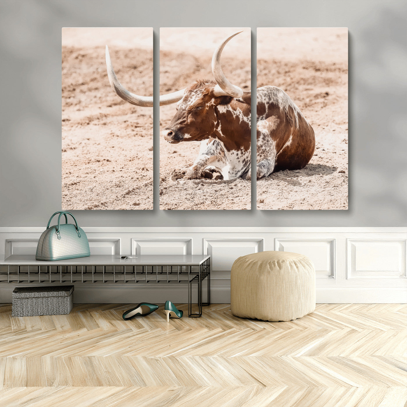 Texas Longhorn bull resting on dusty ground with warm tones, ideal for rustic western or farmhouse-themed wall decor.