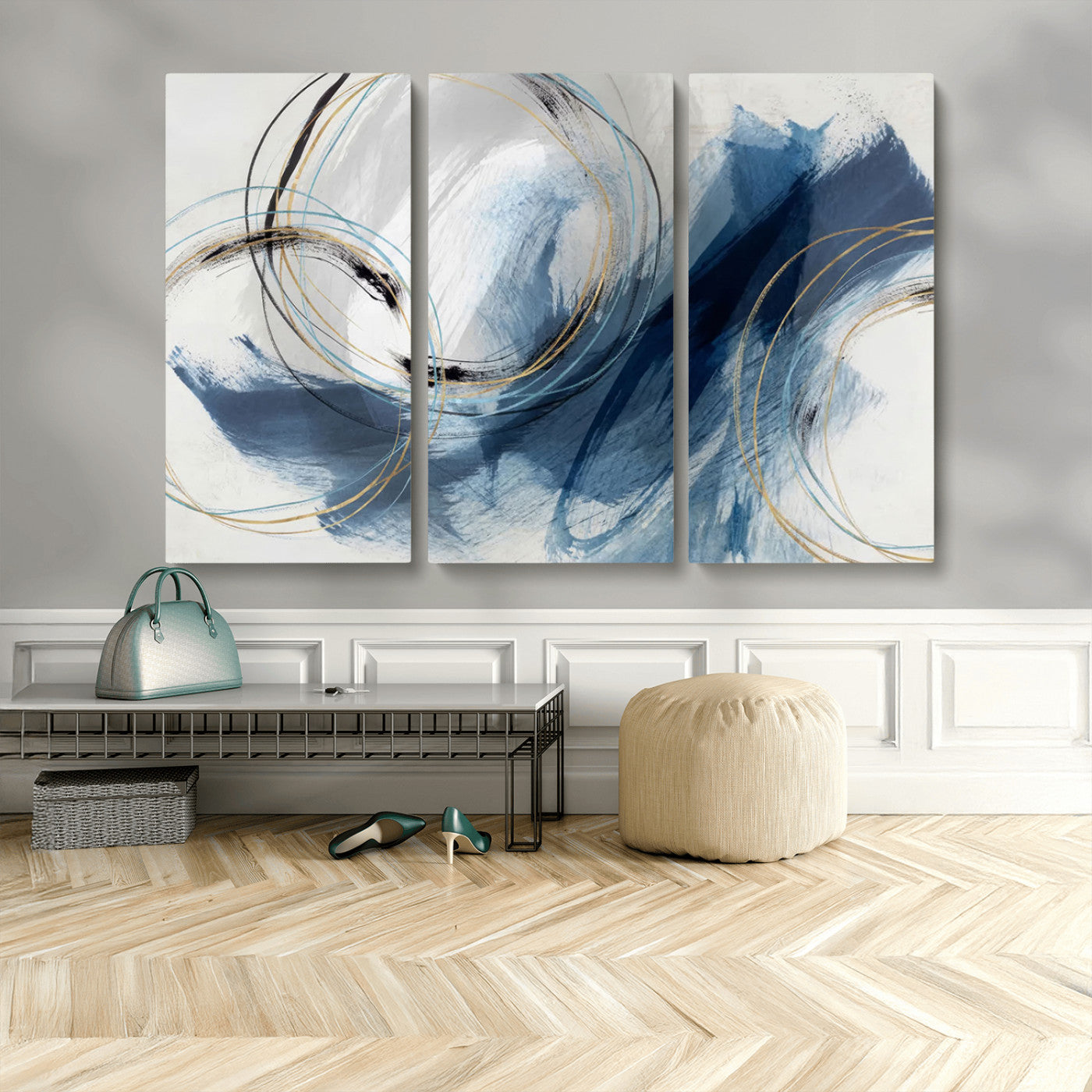 Abstract wall art featuring dynamic brush strokes in shades of blue and gray, overlaid with delicate circular line patterns in gold, black, and light blue on a white background.